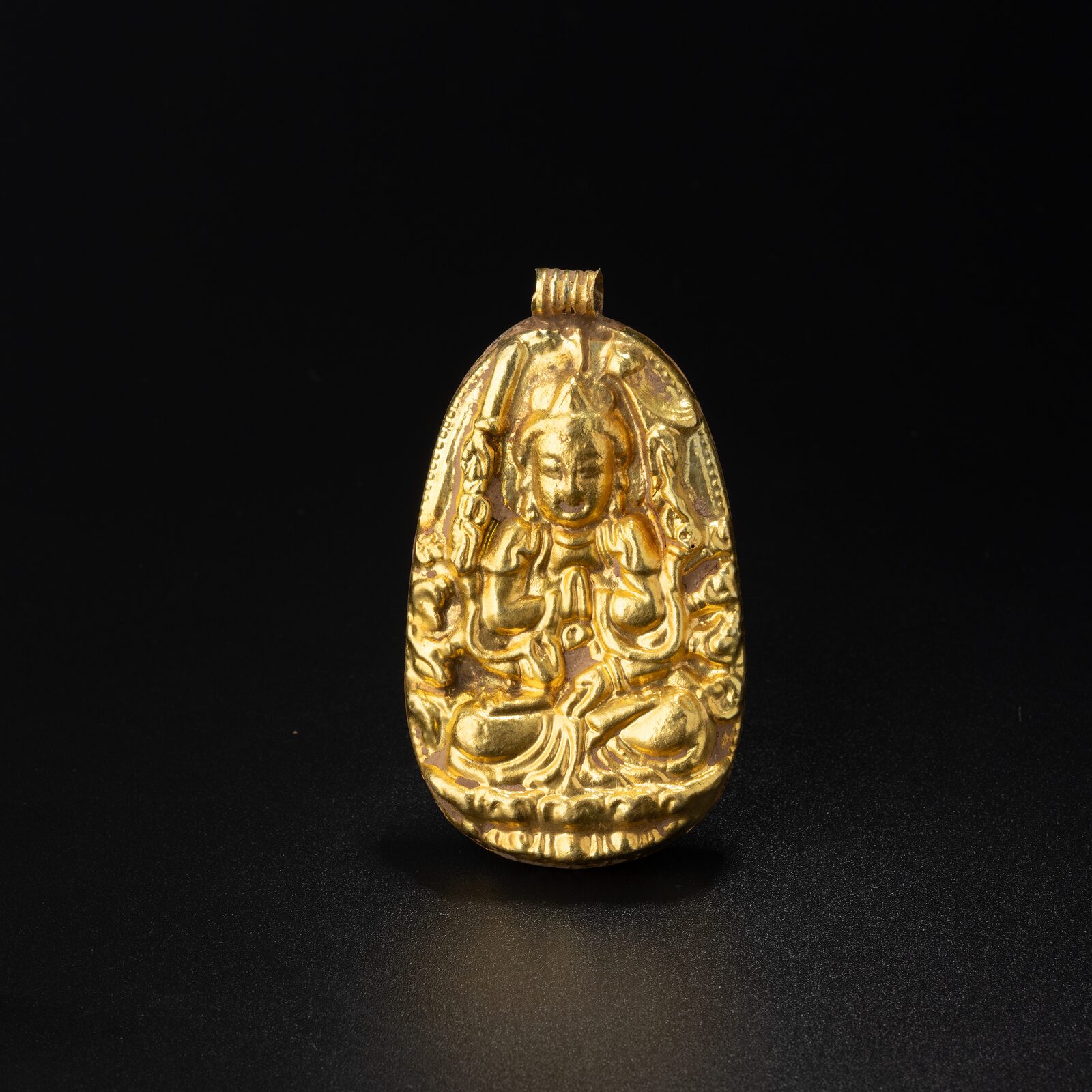 Pendant with a Many-Armed Seated Deity