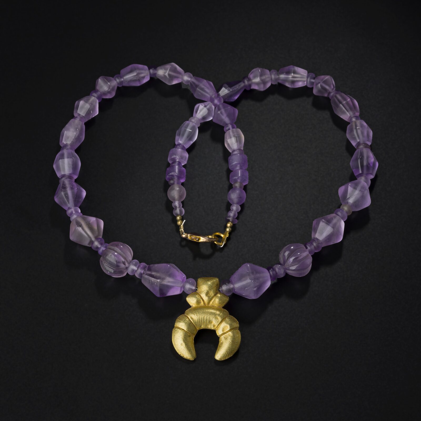 Necklace of Faceted Purple Beads with a Gold Crescent