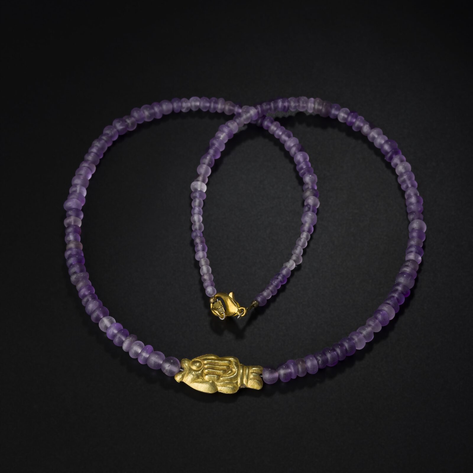 Necklace of Purple Beads with a Gold Centre Bead